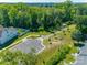 Aerial view of a scenic walking path leading to a parking lot with plenty of parking spaces at 3849 Carl Parmer Dr, Harrisburg, NC 28075
