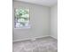 Inviting bedroom with plush carpeting and a window offering natural light and outdoor views at 3919 Briarhill Dr, Charlotte, NC 28215