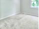 Bright bedroom featuring neutral carpeting, a window, and a fresh coat of paint at 3919 Briarhill Dr, Charlotte, NC 28215