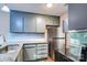 Kitchen featuring gray cabinets, stainless steel appliances, granite countertops, and tile backsplash at 3919 Briarhill Dr, Charlotte, NC 28215