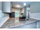 Stylish kitchen featuring granite countertops, gray cabinets, and modern stainless steel appliances at 3919 Briarhill Dr, Charlotte, NC 28215