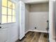 Convenient laundry room with wood-look flooring, utility connections, and bright natural light at 3919 Briarhill Dr, Charlotte, NC 28215