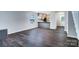 Open-concept living room with modern gray walls and elegant, dark laminate wood flooring throughout at 3919 Briarhill Dr, Charlotte, NC 28215