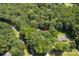 Aerial view showcasing a wooded lot with mature trees and surrounding greenery at 3943 Peggy Ln, Mint Hill, NC 28227