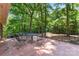 Spacious backyard patio surrounded by mature trees, offering a serene outdoor setting at 3943 Peggy Ln, Mint Hill, NC 28227