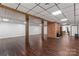 Finished basement offers wood flooring, brick fireplace, and wood support beams at 3943 Peggy Ln, Mint Hill, NC 28227