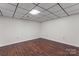 A finished basement space featuring hardwood floors and a drop ceiling with recessed lighting at 3943 Peggy Ln, Mint Hill, NC 28227