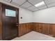 Finished basement entrance with a tiled floor, wood-paneled walls, and exterior access at 3943 Peggy Ln, Mint Hill, NC 28227
