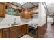 Basement kitchenette with vintage oven and stove and wood cabinets at 3943 Peggy Ln, Mint Hill, NC 28227