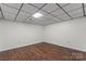 Finished basement area with hardwood floors, a drop ceiling with recessed lighting and neutral walls at 3943 Peggy Ln, Mint Hill, NC 28227