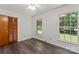 Well-lit bedroom features a closet, wood floors, and natural light from the windows at 3943 Peggy Ln, Mint Hill, NC 28227