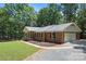 Charming brick home with manicured landscaping, attached garage, and a lovely covered front porch at 3943 Peggy Ln, Mint Hill, NC 28227
