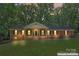 Charming brick home features a manicured lawn, covered porch, and traditional shutters at 3943 Peggy Ln, Mint Hill, NC 28227