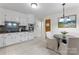 Bright kitchen with stainless appliances, tile floors, and access to other rooms at 3943 Peggy Ln, Mint Hill, NC 28227