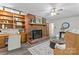 Inviting living room features a brick fireplace, built-in shelving, and an adjacent seating area at 3943 Peggy Ln, Mint Hill, NC 28227
