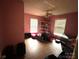 Bedroom with pink walls featuring hardwood floors, a ceiling fan, and natural light at 407 Alton St, Monroe, NC 28110