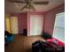 This bedroom has a ceiling fan and hardwood floors and closet for storage at 407 Alton St, Monroe, NC 28110