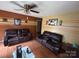 Relaxing living room featuring a ceiling fan, hardwood floors, and comfortable couches at 407 Alton St, Monroe, NC 28110