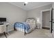 Bedroom featuring neutral carpet, a black metal bed frame, and a black ceiling fan at 423 Solomon St, Charlotte, NC 28216