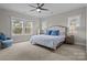 Bedroom with large windows and a comfortable bed adorned with blue pillows at 423 Solomon St, Charlotte, NC 28216