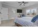 Bedroom with blue bedding, and an ensuite bathroom with a white tiled shower behind a glass door at 423 Solomon St, Charlotte, NC 28216