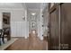 Inviting hallway with hardwood floors, white wainscoting, and an open view to the dining area at 423 Solomon St, Charlotte, NC 28216