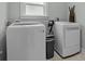 Laundry room with white washer and dryer, gray walls, and a window for natural light at 423 Solomon St, Charlotte, NC 28216