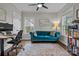 Comfortable office with natural light, a blue sofa, a ceiling fan, and a bookcase at 423 Solomon St, Charlotte, NC 28216