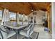 Comfortable sunroom featuring a wood ceiling, tile flooring, and seating for dining or entertaining at 423 Solomon St, Charlotte, NC 28216