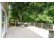 Well maintained deck with table and grill and lovely surrounding trees at 4462 Kellybrook Dr, Concord, NC 28025