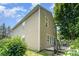 A home's exterior featuring a deck, neutral siding, and large windows at 4462 Kellybrook Dr, Concord, NC 28025
