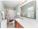 Well-lit bathroom with a shower-tub combination, wood cabinets, and a large vanity at 4462 Kellybrook Dr, Concord, NC 28025