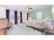 Light-filled bedroom with large windows, a cozy bed, and light green walls at 4462 Kellybrook Dr, Concord, NC 28025