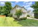 A two-story home boasts a well-maintained lawn and minimal landscaping for a tidy appearance at 4462 Kellybrook Dr, Concord, NC 28025