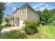 Low angle view of a charming two-story home with tidy landscaping and a one-car garage at 4462 Kellybrook Dr, Concord, NC 28025