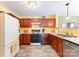 Efficient kitchen design with wooden cabinets, white countertops, and essential appliances at 4462 Kellybrook Dr, Concord, NC 28025