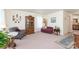 Bright living room featuring a hutch, comfortable seating, neutral walls and carpet, and natural light at 4462 Kellybrook Dr, Concord, NC 28025