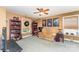 Third entertainment room boasts a ceiling fan, built-in bookshelves, and a comfortable seating area at 4462 Kellybrook Dr, Concord, NC 28025