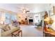 Sunlit living room featuring neutral walls, plush carpeting, a ceiling fan, and inviting furniture at 4462 Kellybrook Dr, Concord, NC 28025