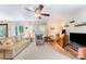 Bright living room with neutral walls, plush carpeting, ceiling fan, and comfortable furniture at 4462 Kellybrook Dr, Concord, NC 28025