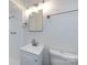Bathroom with a new vanity, mirror, shower, toilet, and new wall mounted lighting at 4601 Mendham Dr, Charlotte, NC 28215