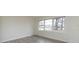Bright bedroom with large window, modern flooring, and neutral walls, providing a serene and comfortable living space at 4601 Mendham Dr, Charlotte, NC 28215