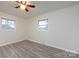Bedroom with neutral walls, wood-look floors and two windows for natural light at 4601 Mendham Dr, Charlotte, NC 28215