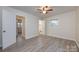 Bedroom features neutral walls, wood-look floors, and an ensuite bath at 4601 Mendham Dr, Charlotte, NC 28215