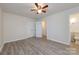 Bedroom boasts neutral walls, wood-look floors, and a closet with an ensuite bath at 4601 Mendham Dr, Charlotte, NC 28215