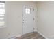 Inviting entryway with a bright white door, complemented by modern flooring and a window for natural light at 4601 Mendham Dr, Charlotte, NC 28215