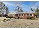 Charming brick home featuring a landscaped front yard and classic architectural details, perfect for suburban living at 4601 Mendham Dr, Charlotte, NC 28215