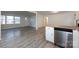Open-concept kitchen featuring stainless dishwasher and new flooring at 4601 Mendham Dr, Charlotte, NC 28215