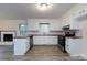 Open kitchen features white cabinetry and stainless steel appliances with new flooring at 4601 Mendham Dr, Charlotte, NC 28215