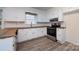 Updated kitchen with white cabinets, stainless appliances, new flooring, and bright natural light at 4601 Mendham Dr, Charlotte, NC 28215
